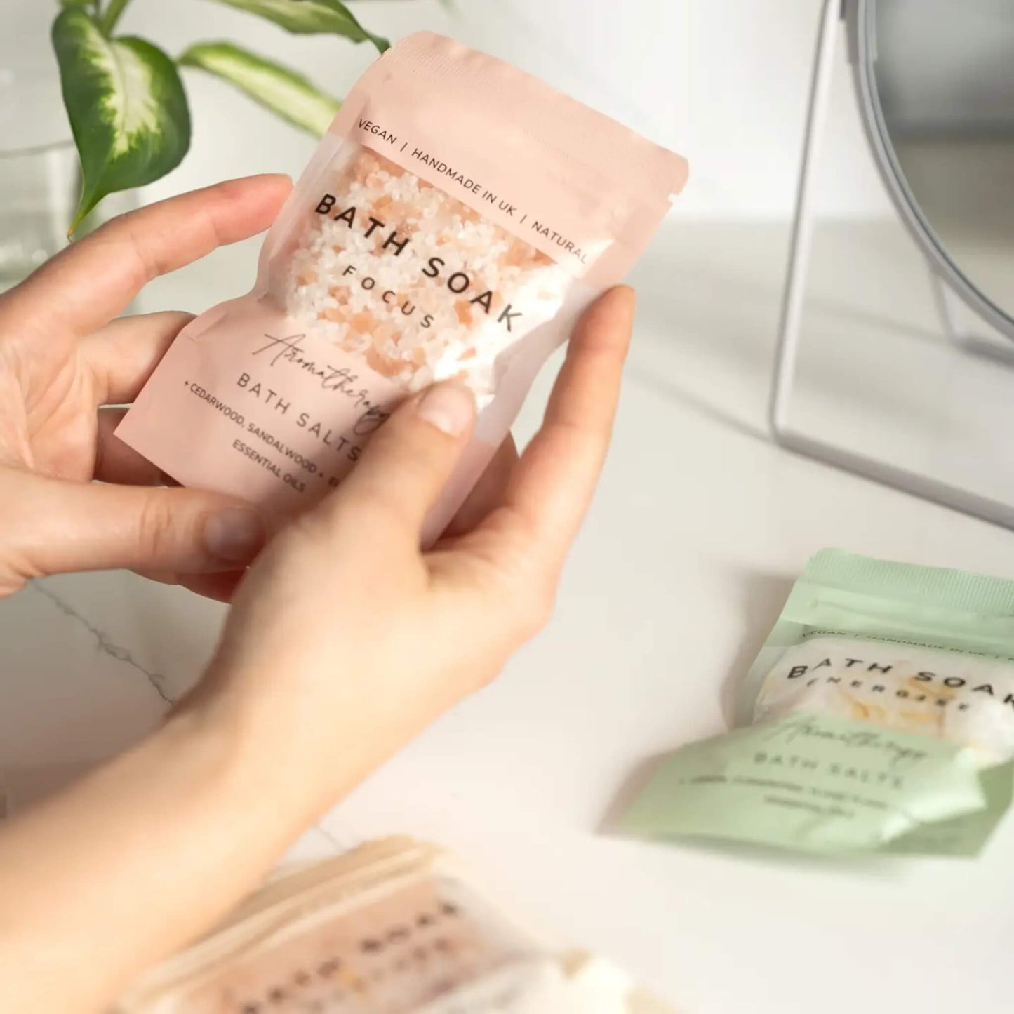 Person holding sachet of Arthur Betsy Focus Bath Salts with natural oils