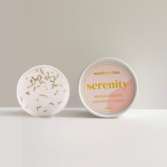 Serenity Aromatherapy Shower Steamer alongside branded pot – calming, citrus blend of bergamot, grapefruit and rosemary.