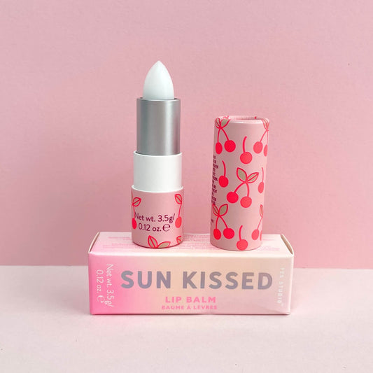 Cherry lip balm on top of cherry lip balm packaging box