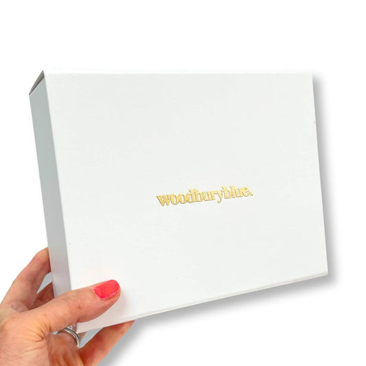 Luxury white gift box with magnetic ribbon pull tab and gold Woodbury Blue logo
