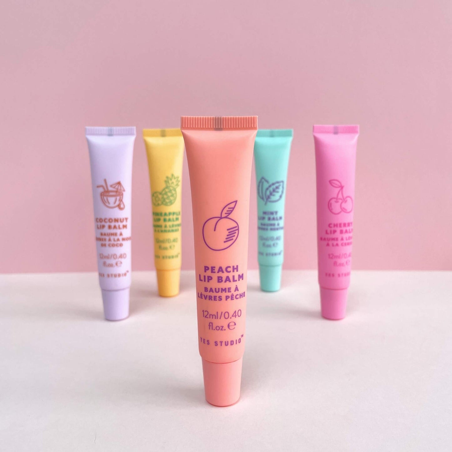 Peach scented lip balm with other colourful, fruity lip balm tubes