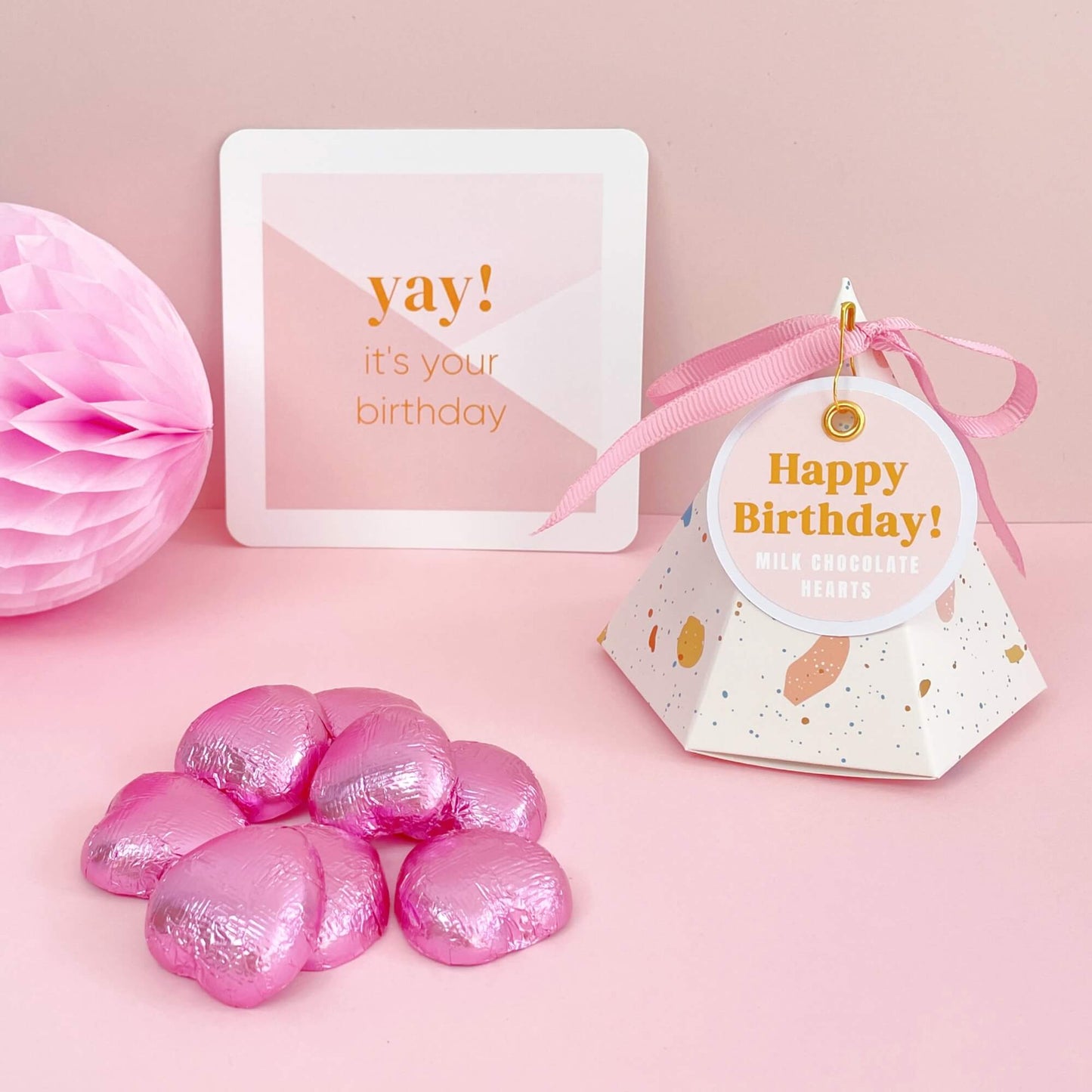 Happy birthday chocolate filled pyramid gift box with pink foil chocolate hearts