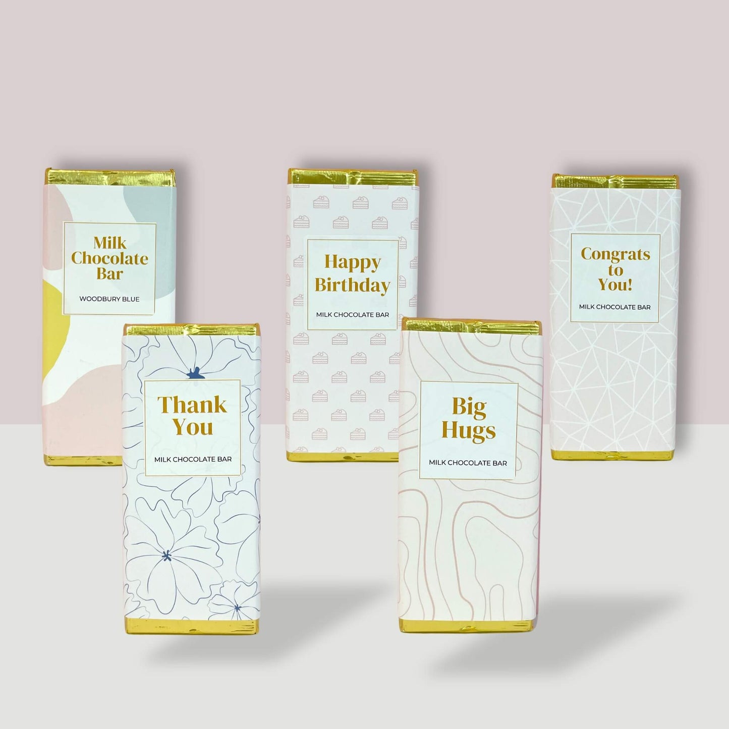 A selection of five milk chocolate bars from Woodbury Blue with messages including "Happy Birthday", "Thank You", "Big Hugs", "Congrats to You!", and a plain branded bar – perfect for gifting across all occasions.