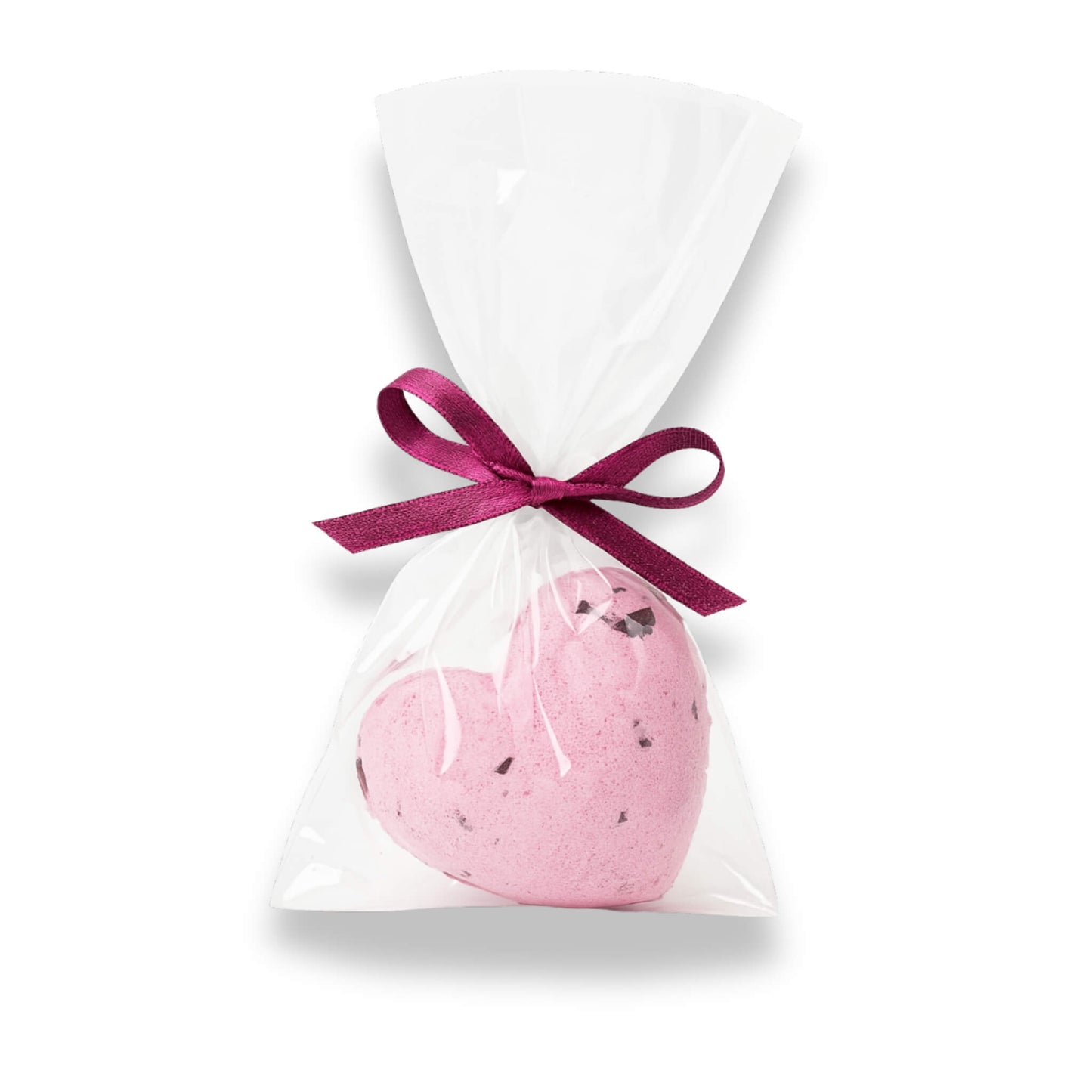 Pink heart-shaped bath bomb in a clear bag with a pink ribbon on a white background