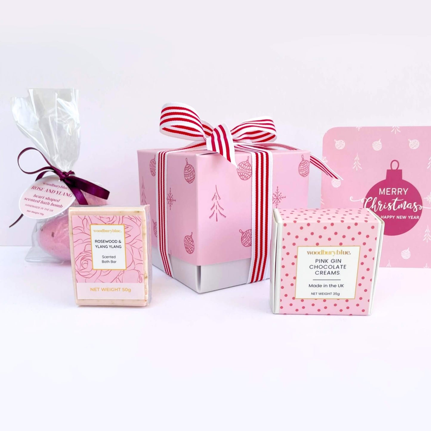 Pink-themed chocolate and candy packaging with festive designs on a white background