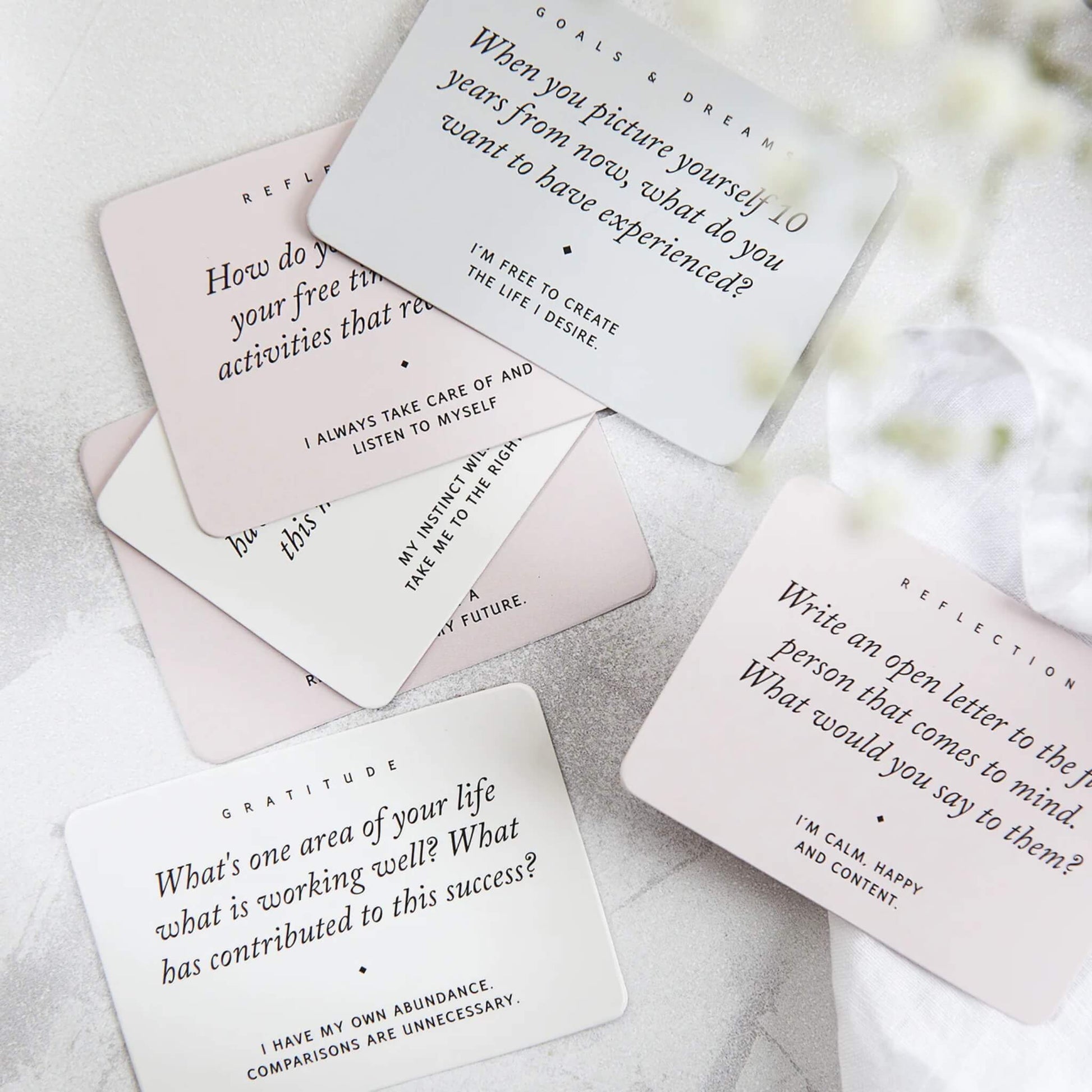 Selection of journal cards with prompts and affirmations on a white background