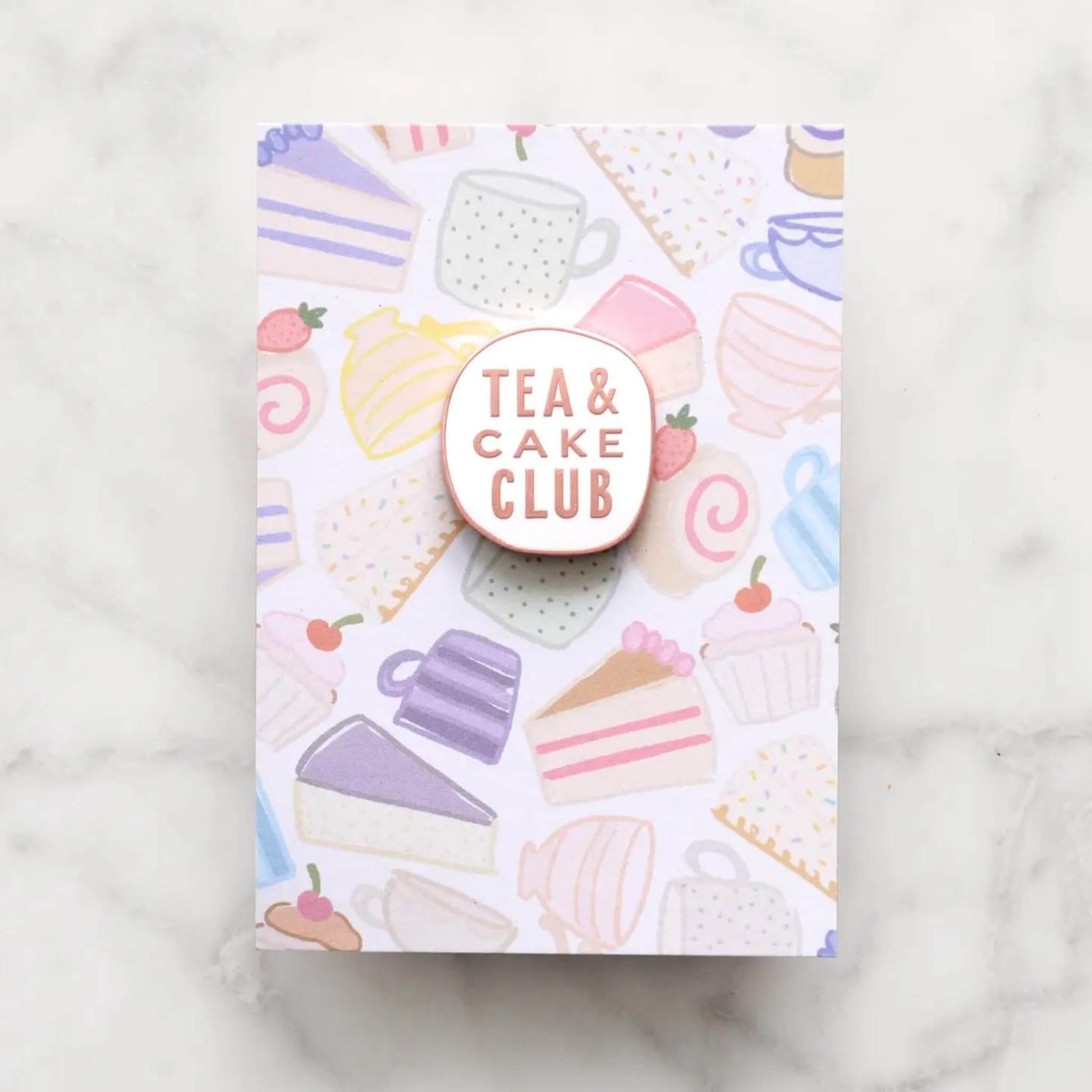 Tea and Cake Club enamel pin badge with rose gold lettering on illustrated cake and teacup backing card