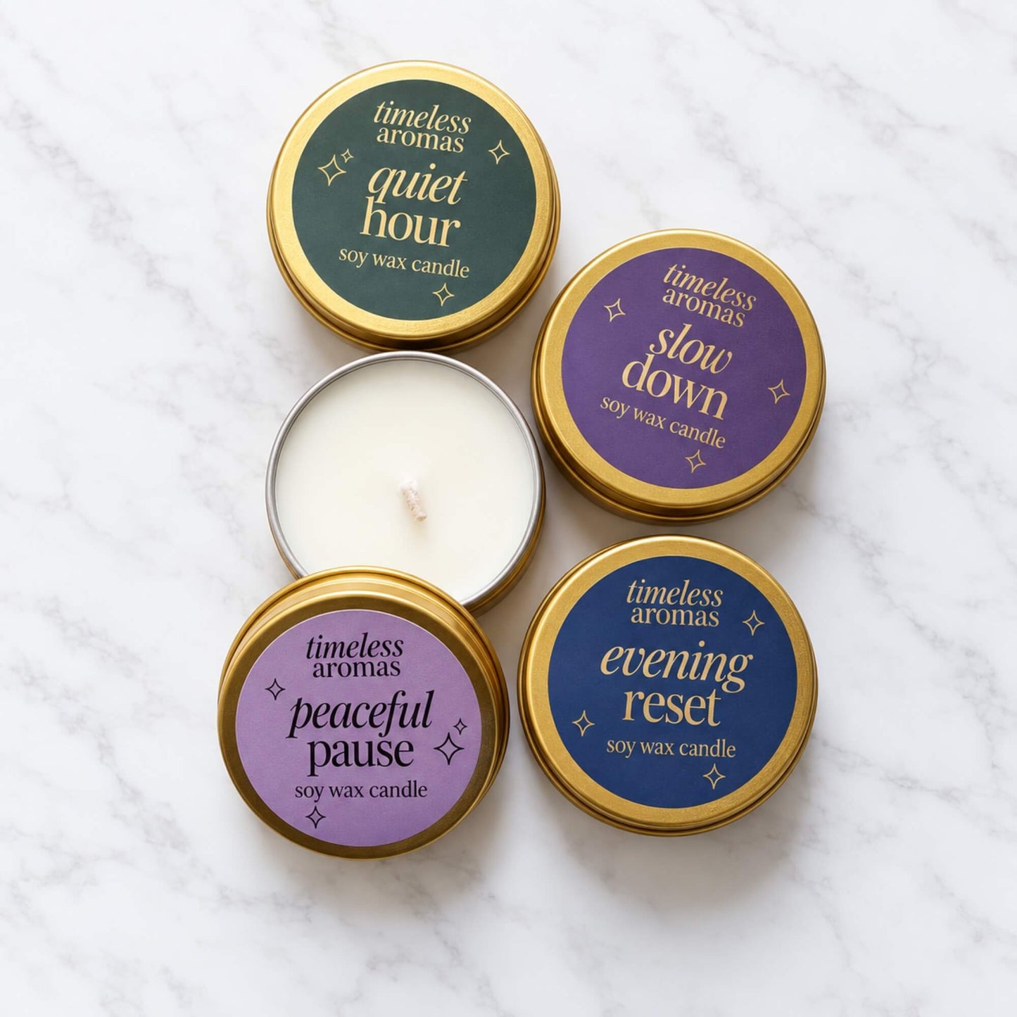 Collection of Timeless Aromas mini soy wax candles in gold tins, including Slow Down, Quiet Hour, Peaceful Pause and Evening Reset