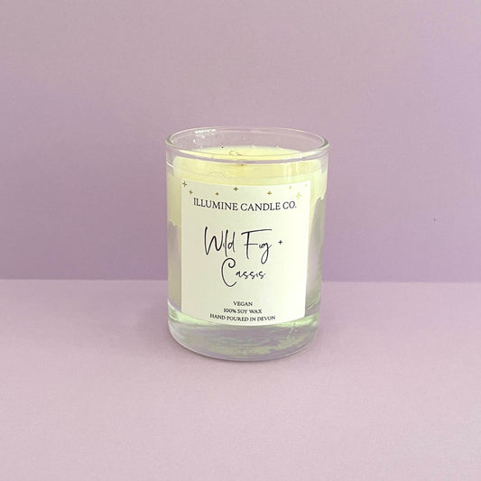 Wild fig and cassis soy wax candle with purple back drop