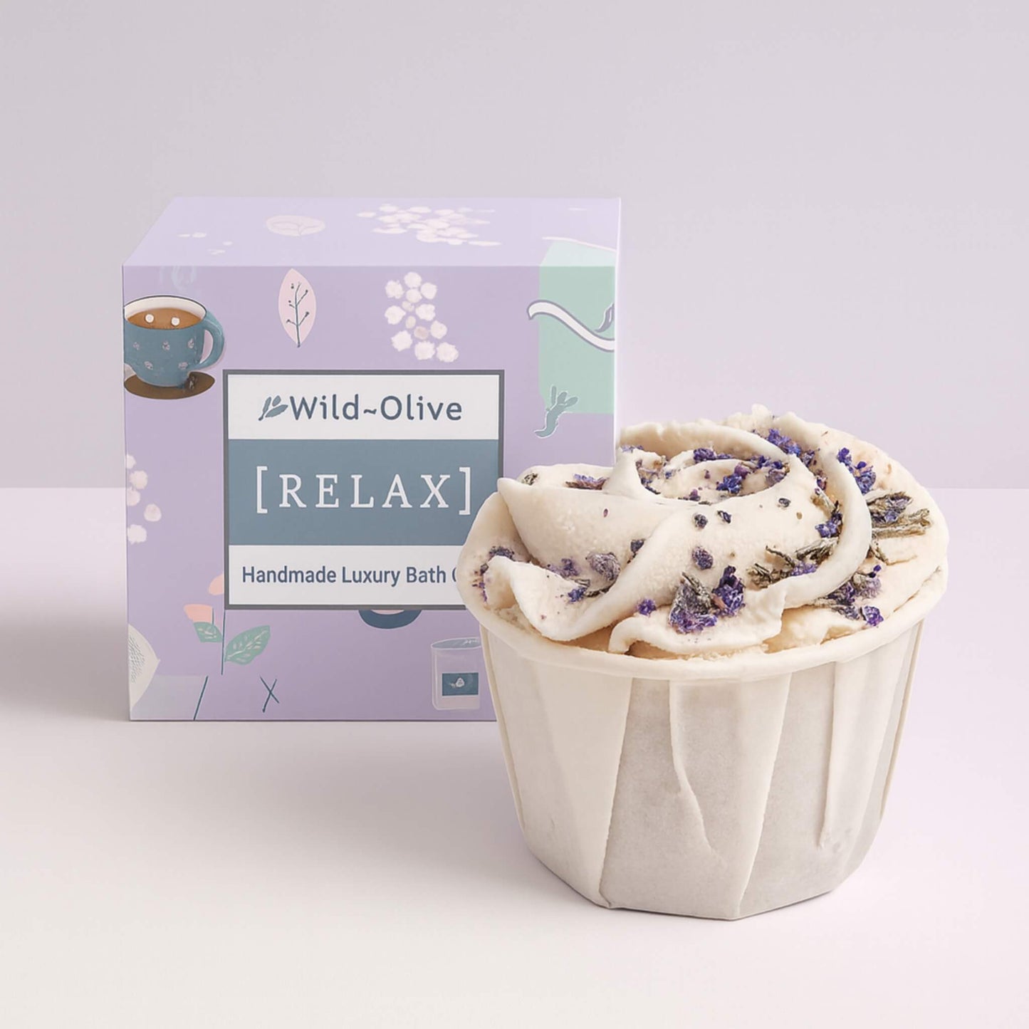 Handmade luxury bath bomb with Wild Olive packaging on a white background