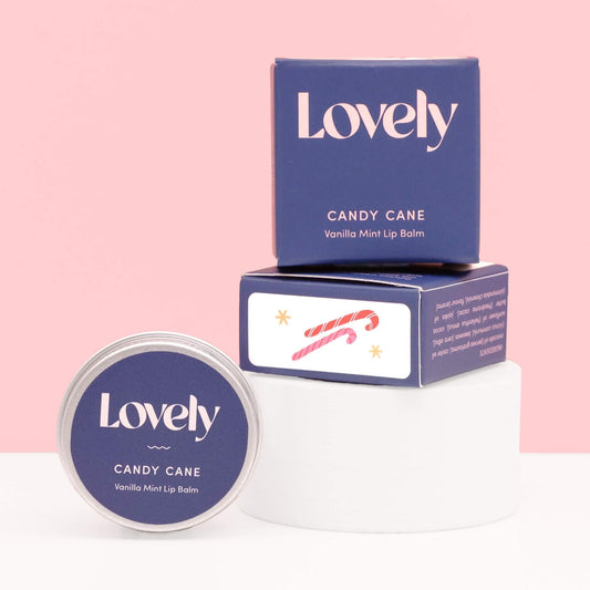 Candy Cane Vanilla Mint Lip Balm by Lovely Skincare in navy packaging on pink background