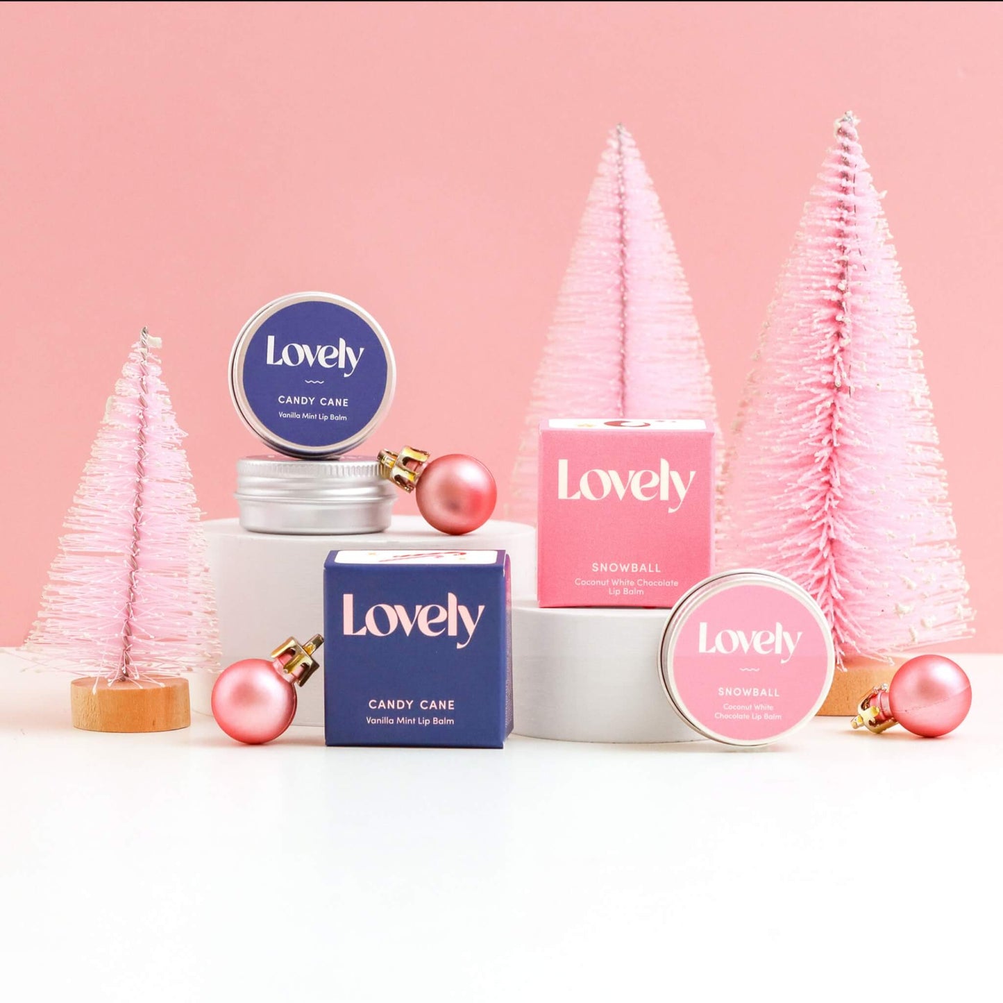 Lovely Skincare Candy Cane and Snowball Lip Balms with pink bottle brush Christmas trees