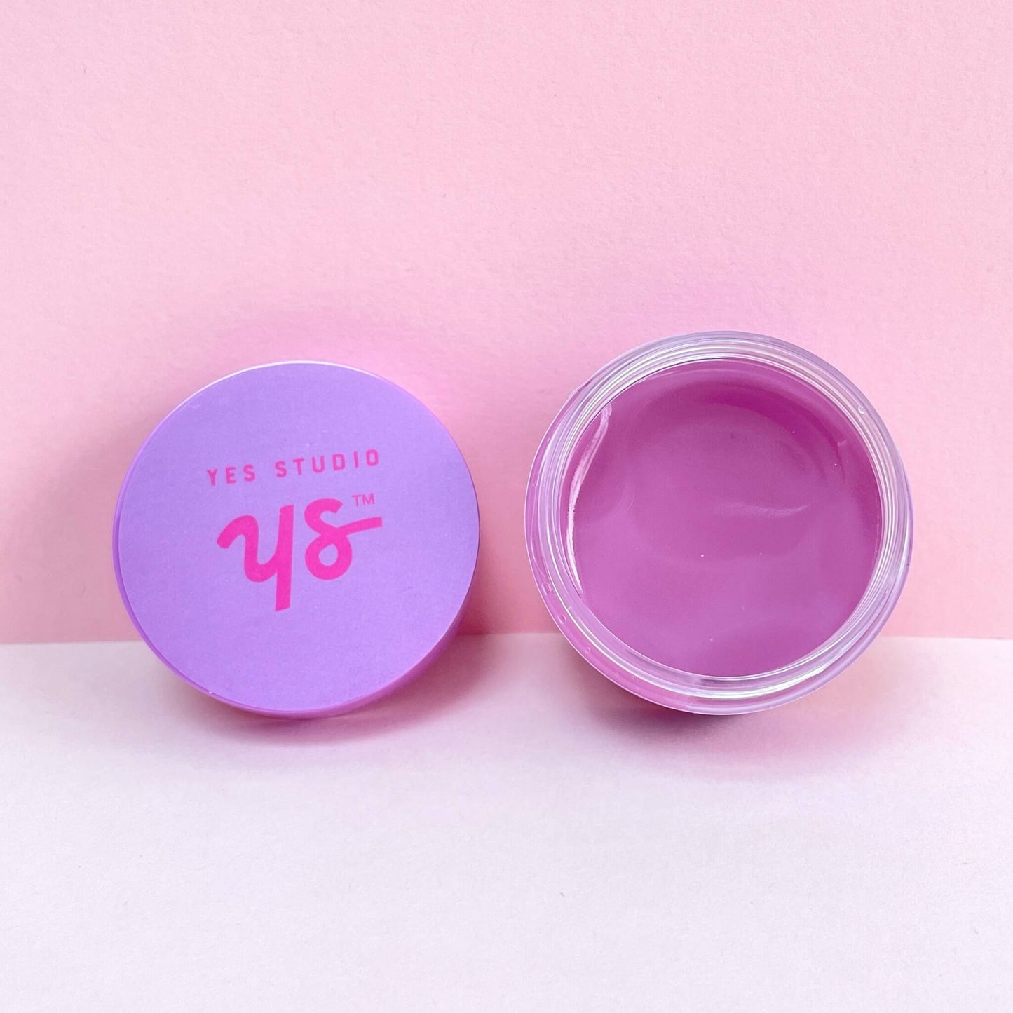 Open pot of vanilla lip mask with lid