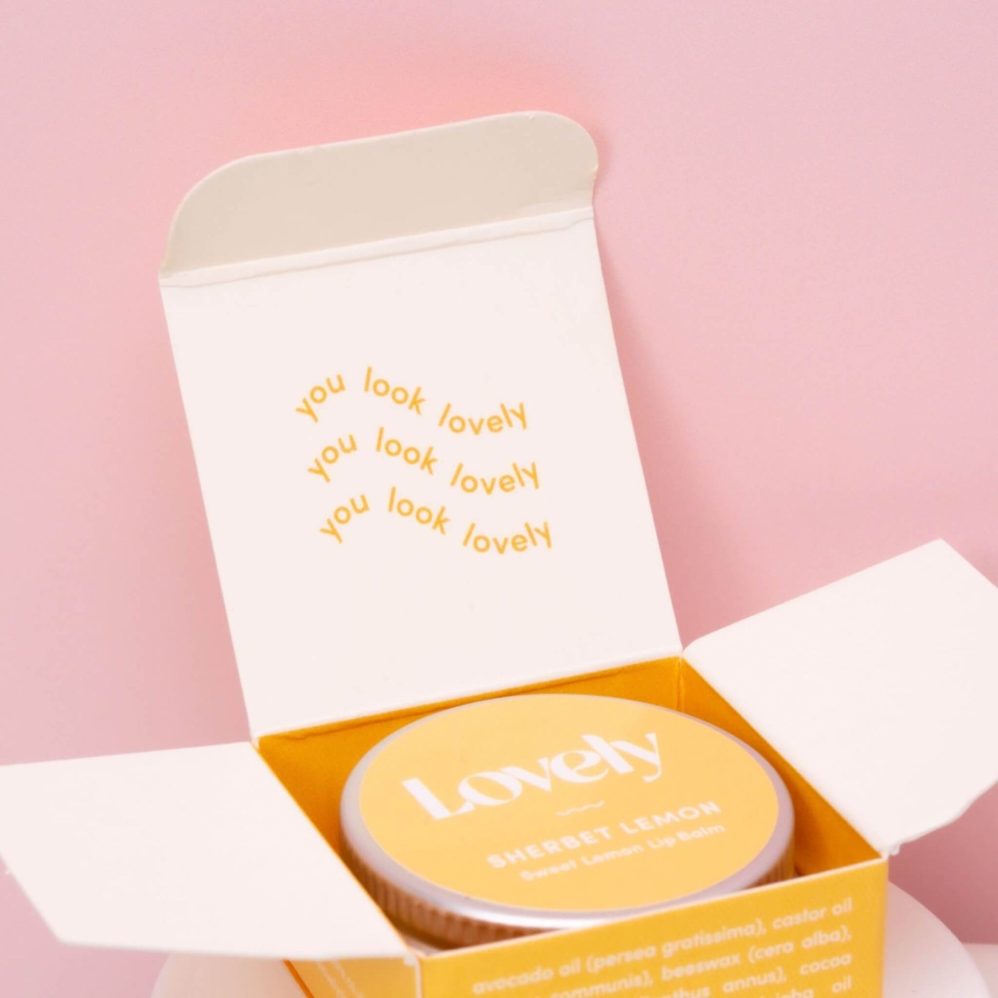 Lemon sherbet lip balm in a yellow packaging box with the words "you look lovely"