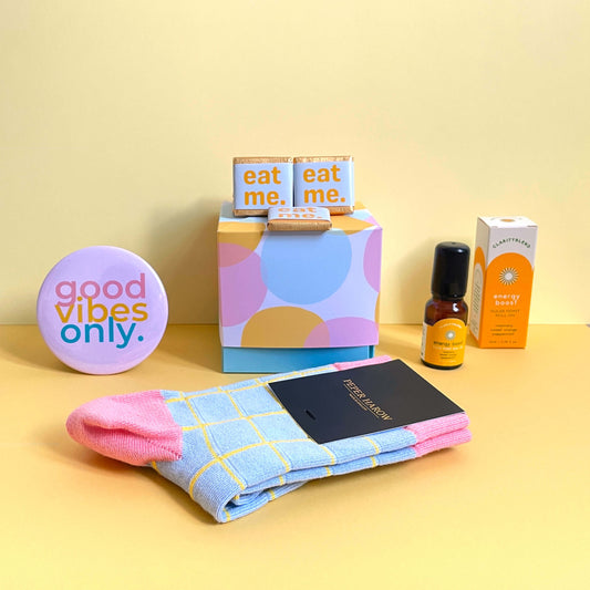 Blue, yellow and pink themed Good Vibes gift box with mood boosting products