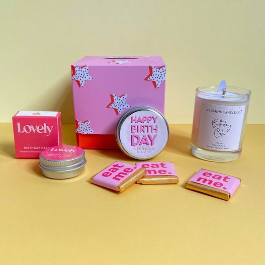A pink and orange themed gift box with a star pattern containing birthday treats