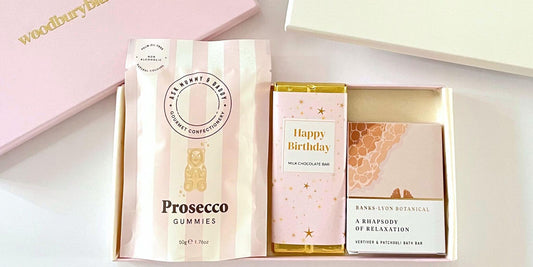 Letterbox birthday gift box with prosecco gummies, happy birthday milk chocolate bar and botanical soap, presented in a slim blush gift box ready for UK delivery