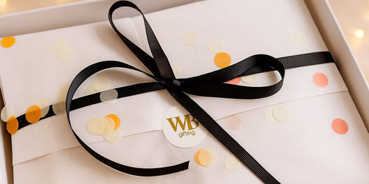 Thoughtfully wrapped just because gift box with tissue paper, ribbon and confetti, suitable for sending after Christmas