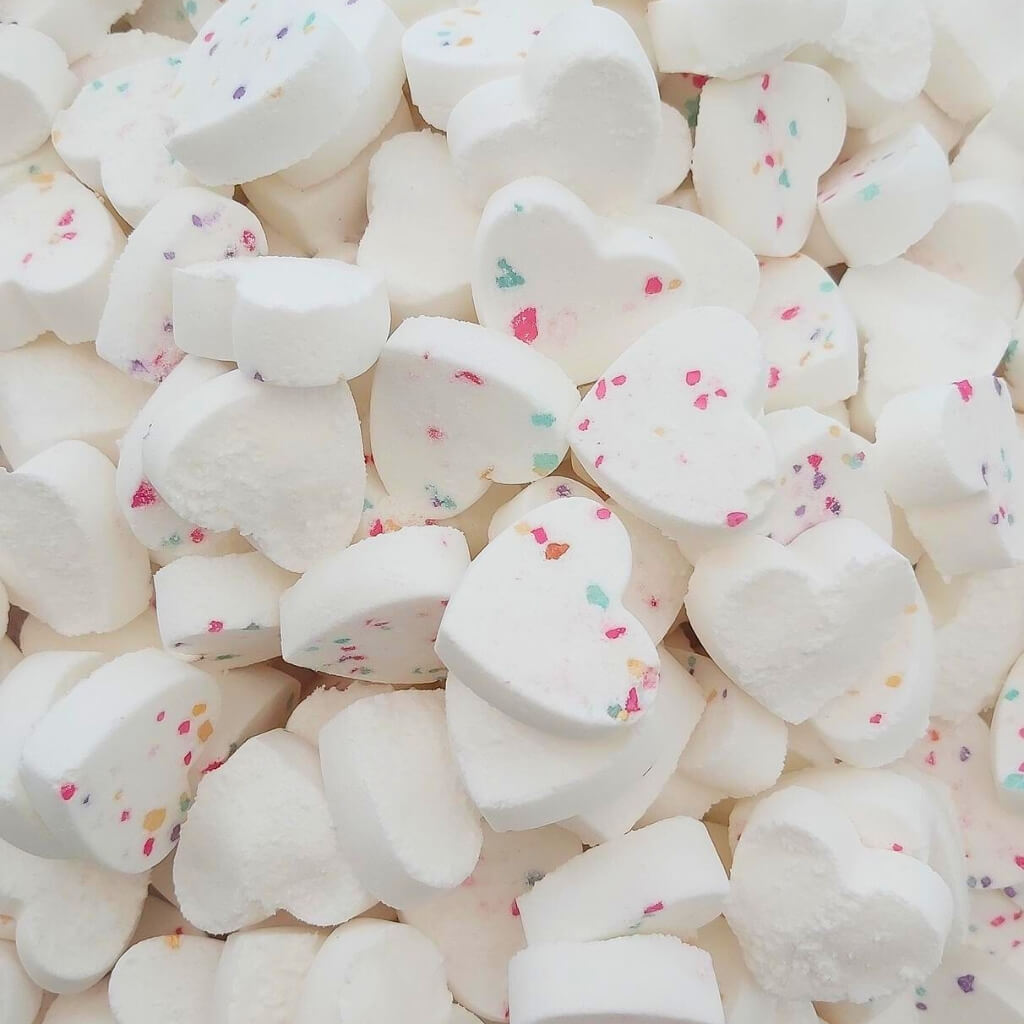 Lots of mini heart shaped birthday cake scented bath bombs