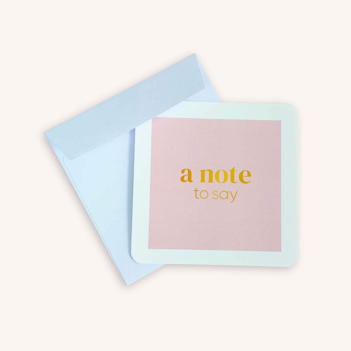 A note to say notecard with pale blue envelope, featuring a pink design and gold text for handwritten gift messages