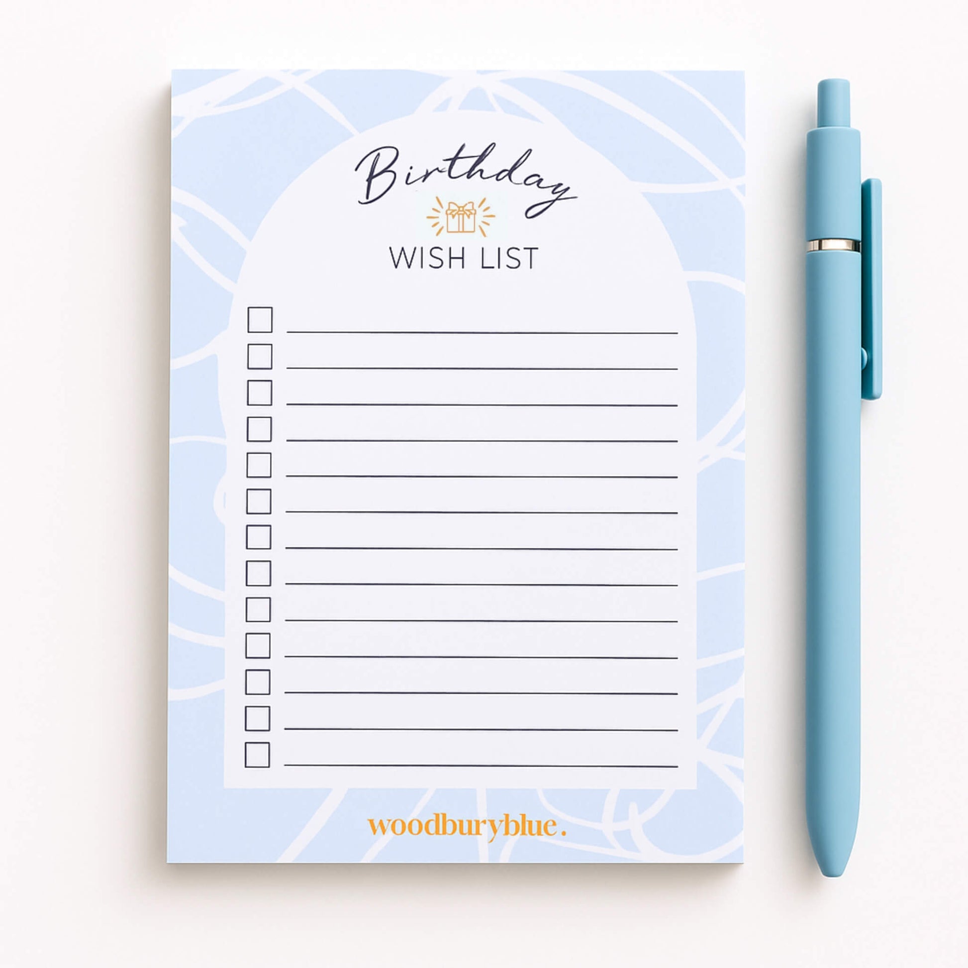Birthday wish list notepad with a pen on a white background