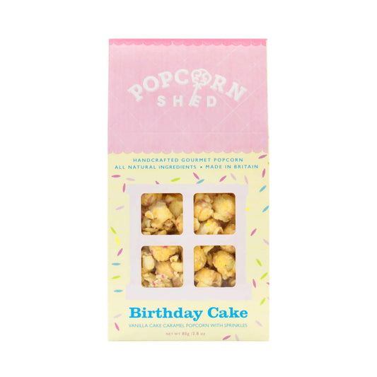 Birthday Cake Gourmet Popcorn 80g gift box with vanilla cake flavoured caramel popcorn and colourful sprinkles visible through the front window.