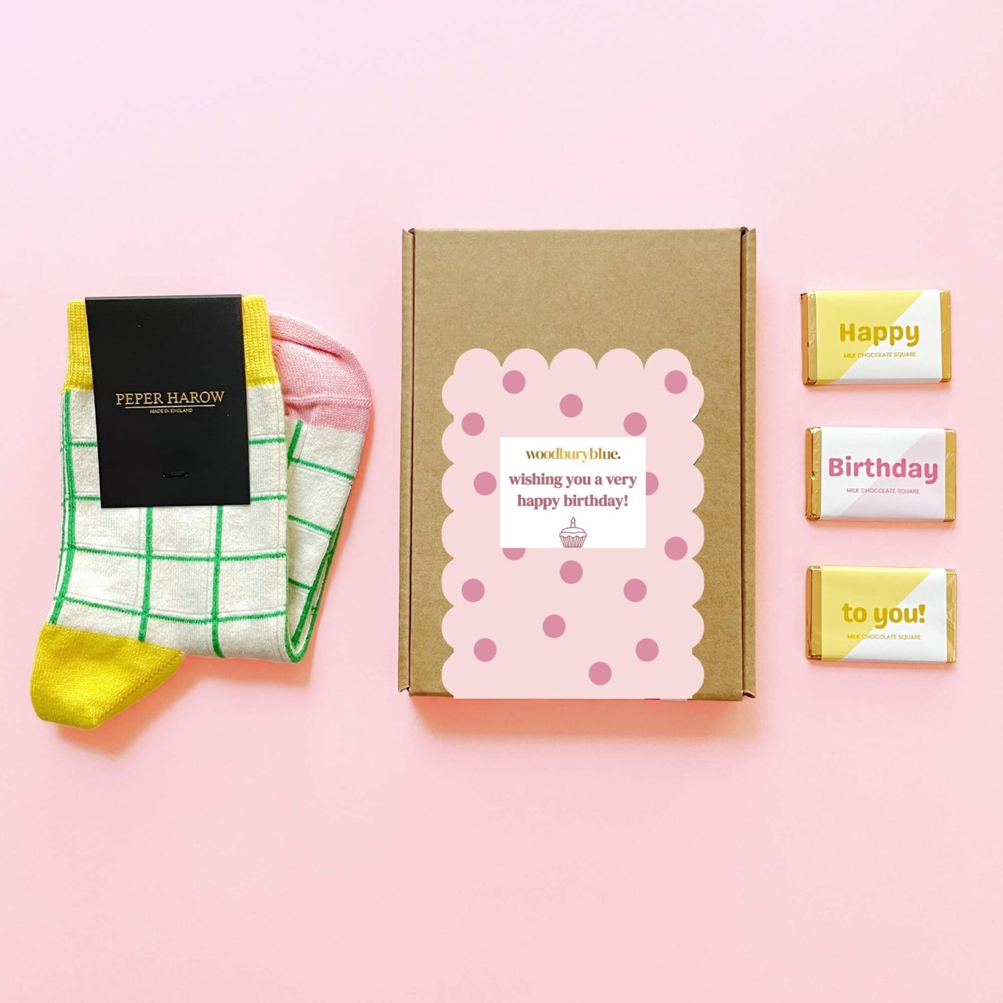 Birthday letterbox gift box with yellow and pink socks and three milk chocolate squares by Woodbury Blue.