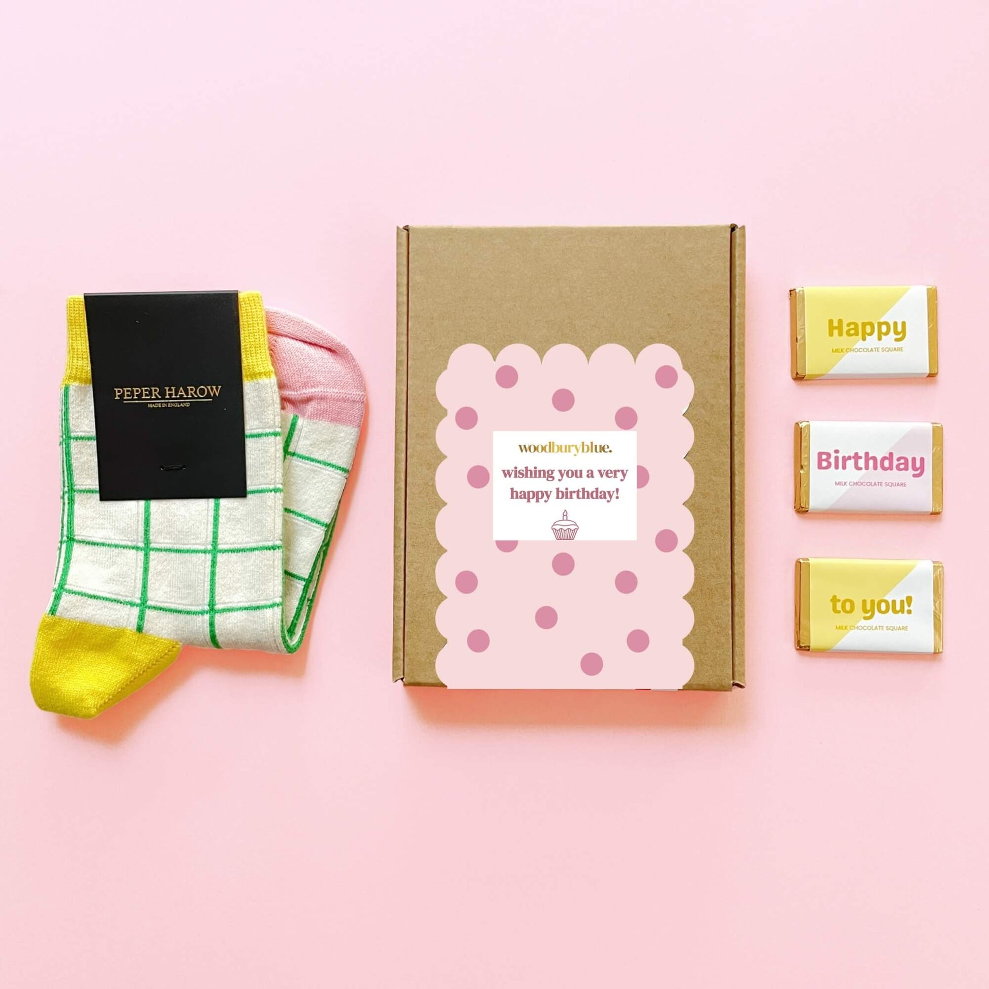 Birthday letterbox gift box with yellow and pink socks and three milk chocolate squares by Woodbury Blue.