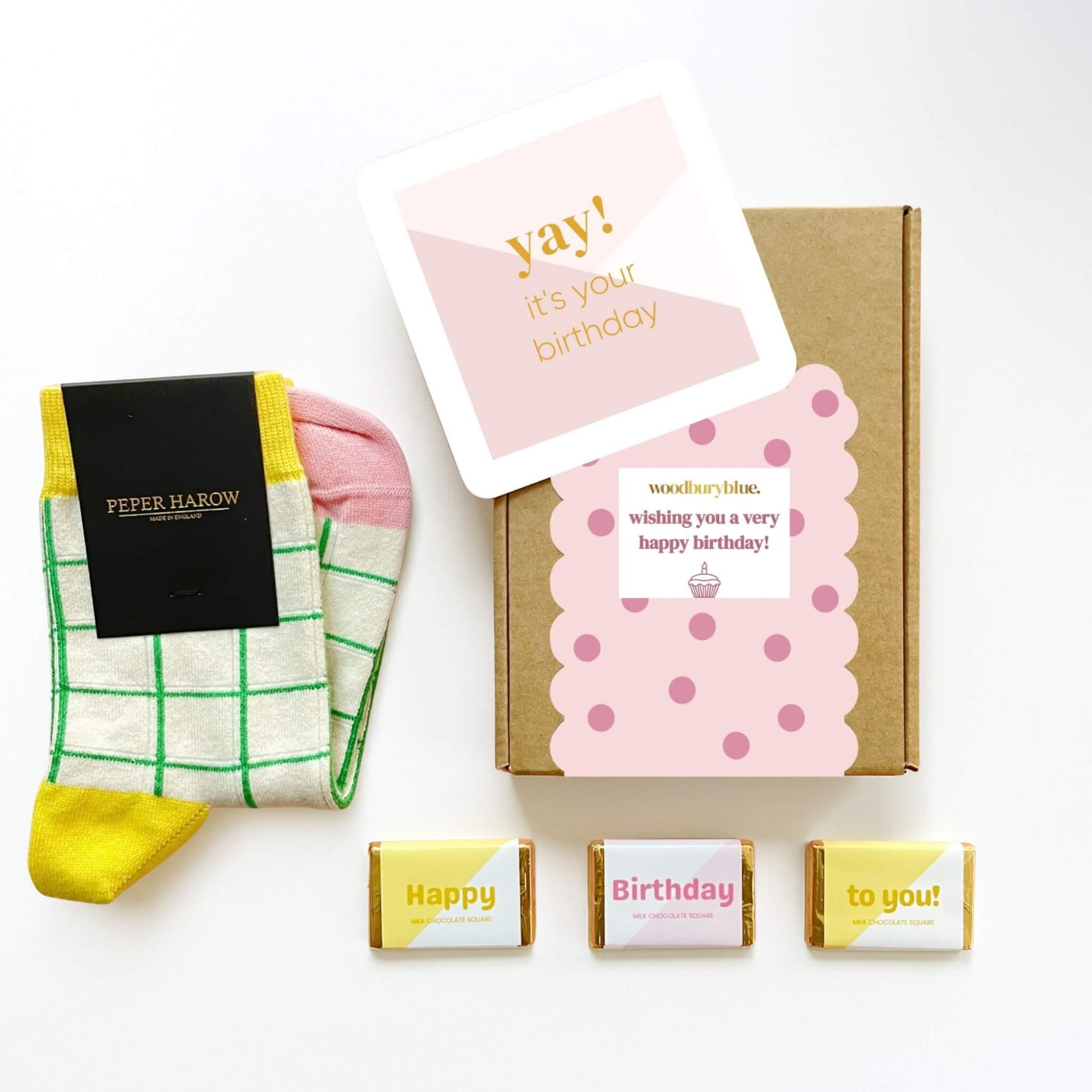 Happy Birthday Socks and Chocolates Letterbox Gift with yellow and pink socks, birthday card and pastel chocolates by Woodbury Blue.