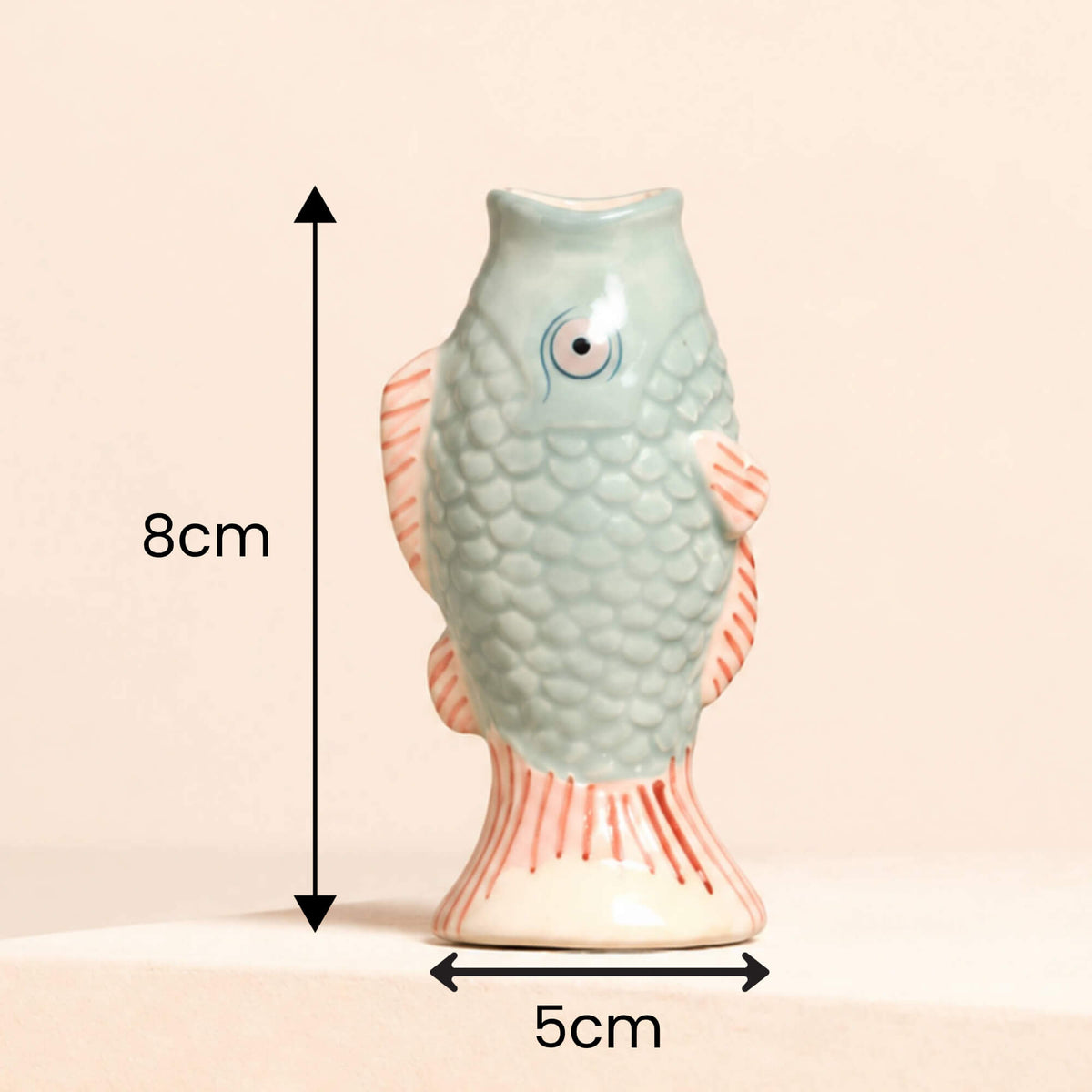 Lisa Angel blue ceramic mini fish bud vase with pink fins and textured scales, showing its dimensions of 8cm high and 5cm wide.