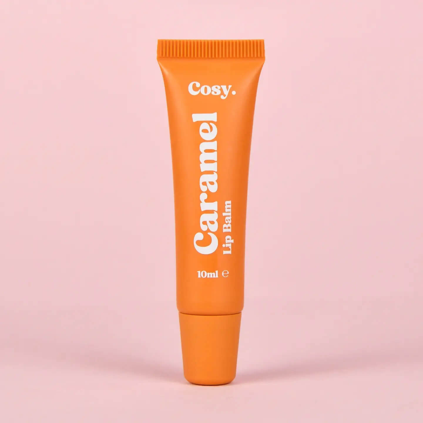Cosy Cosmetics Caramel Lip Balm 10ml in an orange tube with a nourishing vegan formula for soft, moisturised lips.
