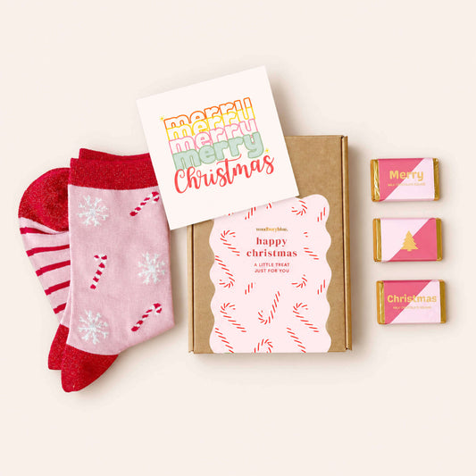 Christmas Wishes Socks and Chocs Letterbox Gift with pink candy cane bamboo socks, three wrapped milk chocolates, Christmas card and Woodbury Blue gift box.