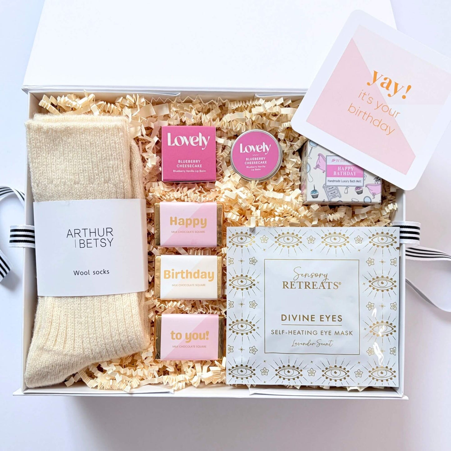 Cosy Birthday Gift Box with wool socks, self heating eye mask, birthday bath melt, lip balm, chocolate squares and birthday card.