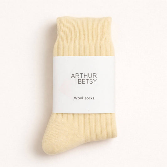Cream wool sock by 'Arthur Betsy' on a light beige background