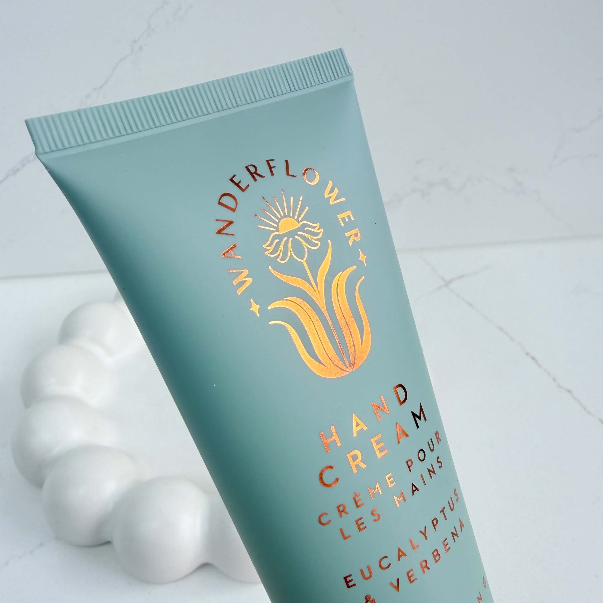 Close-up of eucalyptus and verbena hand cream tube by Wanderflower