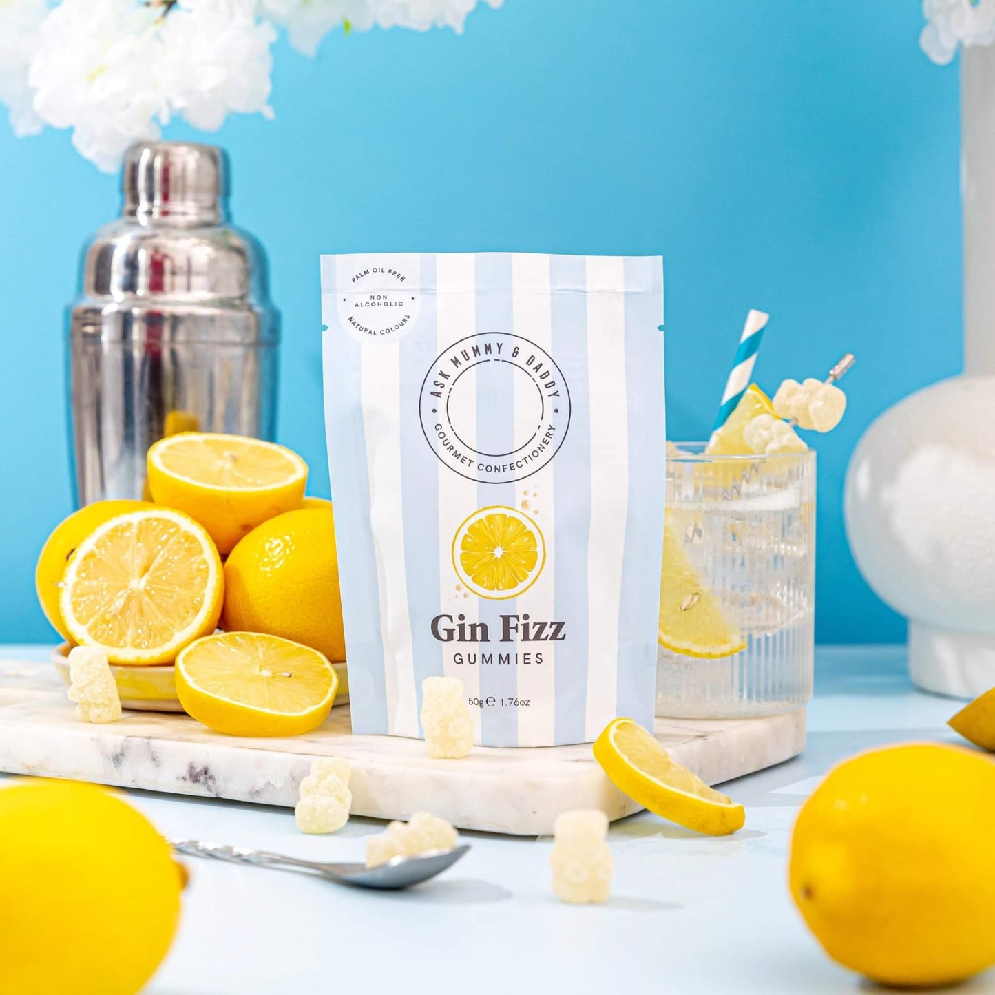 Gin fizz cocktail gummies with a gin drink and fresh lemons