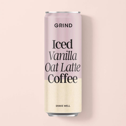 Grind Iced Vanilla Oat Latte Coffee can, 250ml, shown upright against a soft pink background.