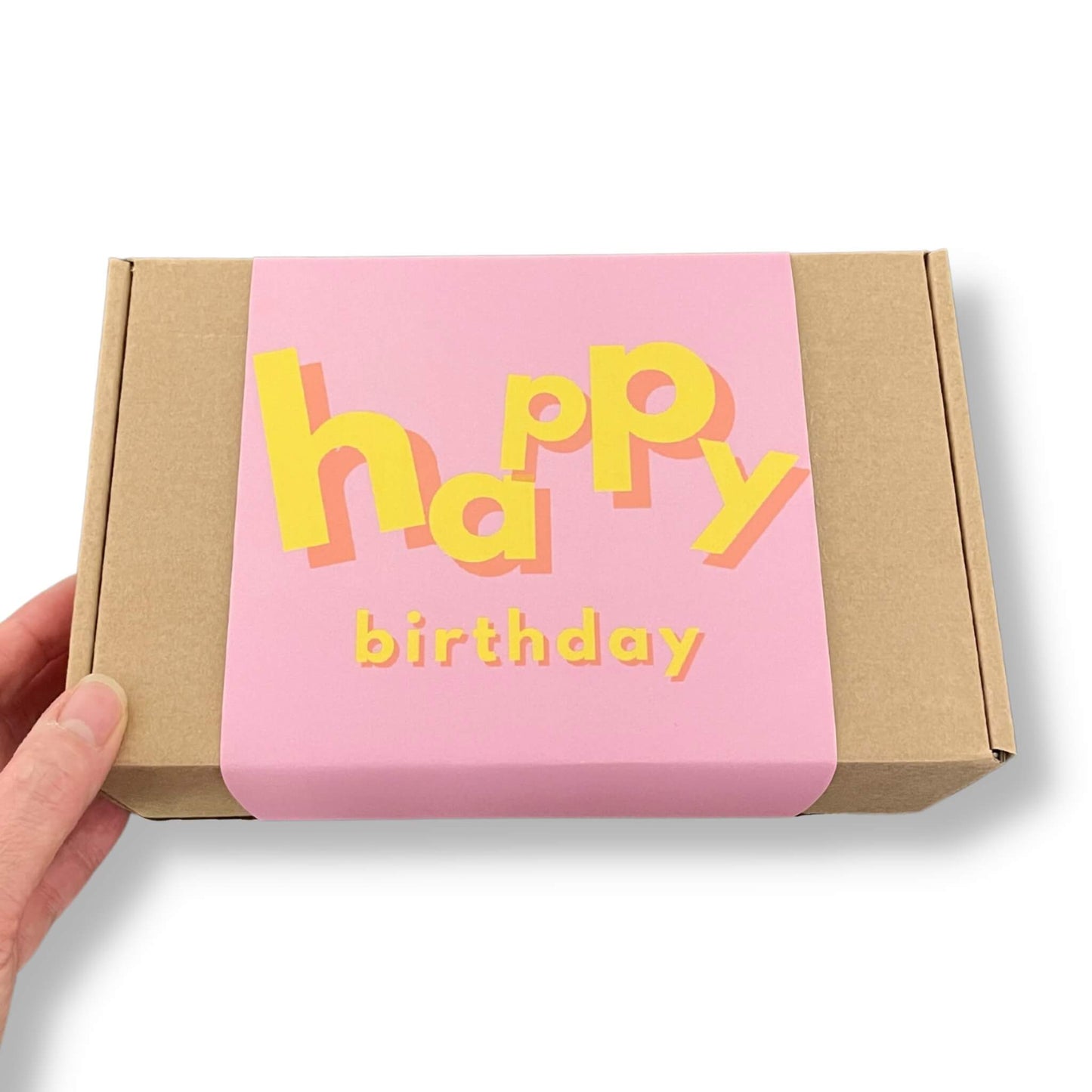 Kraft gift box with a pink and yellow sleeve and Happy Birthday text