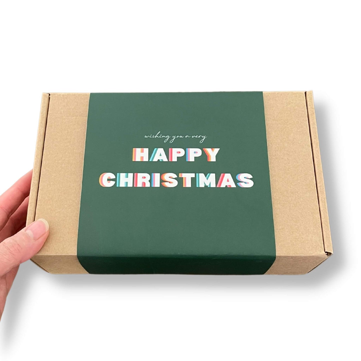 Kraft gift box with a green sleeve and happy christmas on the front