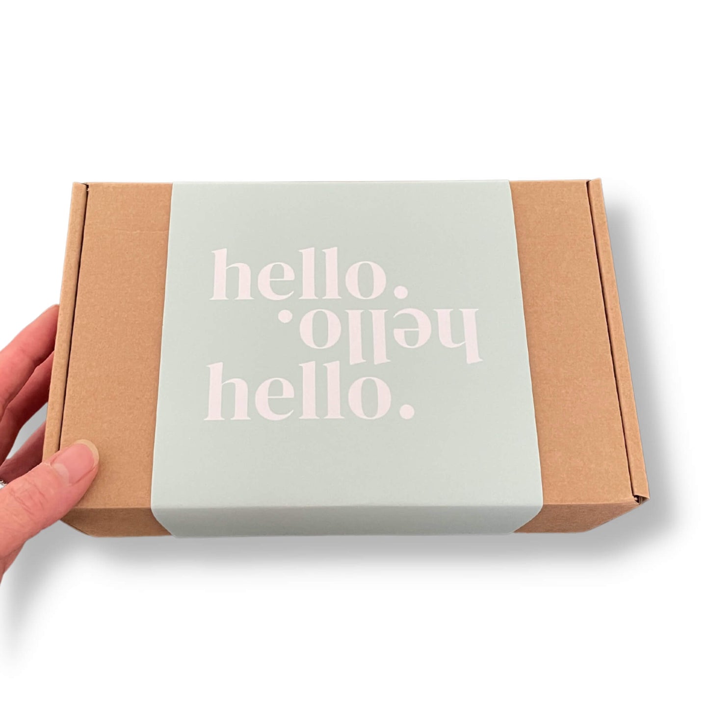 Kraft gift box with a pale blue/green sleeve and 'hello.hello.hello' text on the front