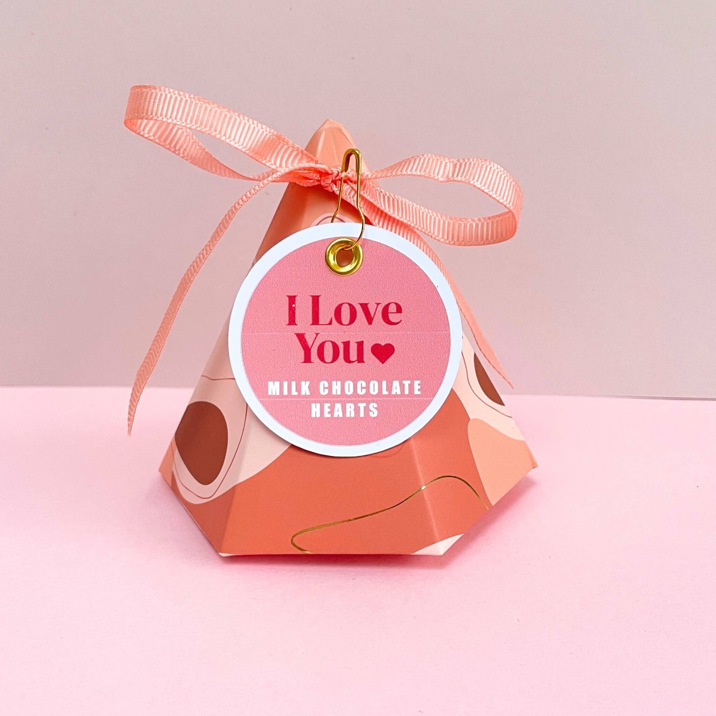 Pyramid gift box filled with milk chocolate hearts and an I Love You gift tag