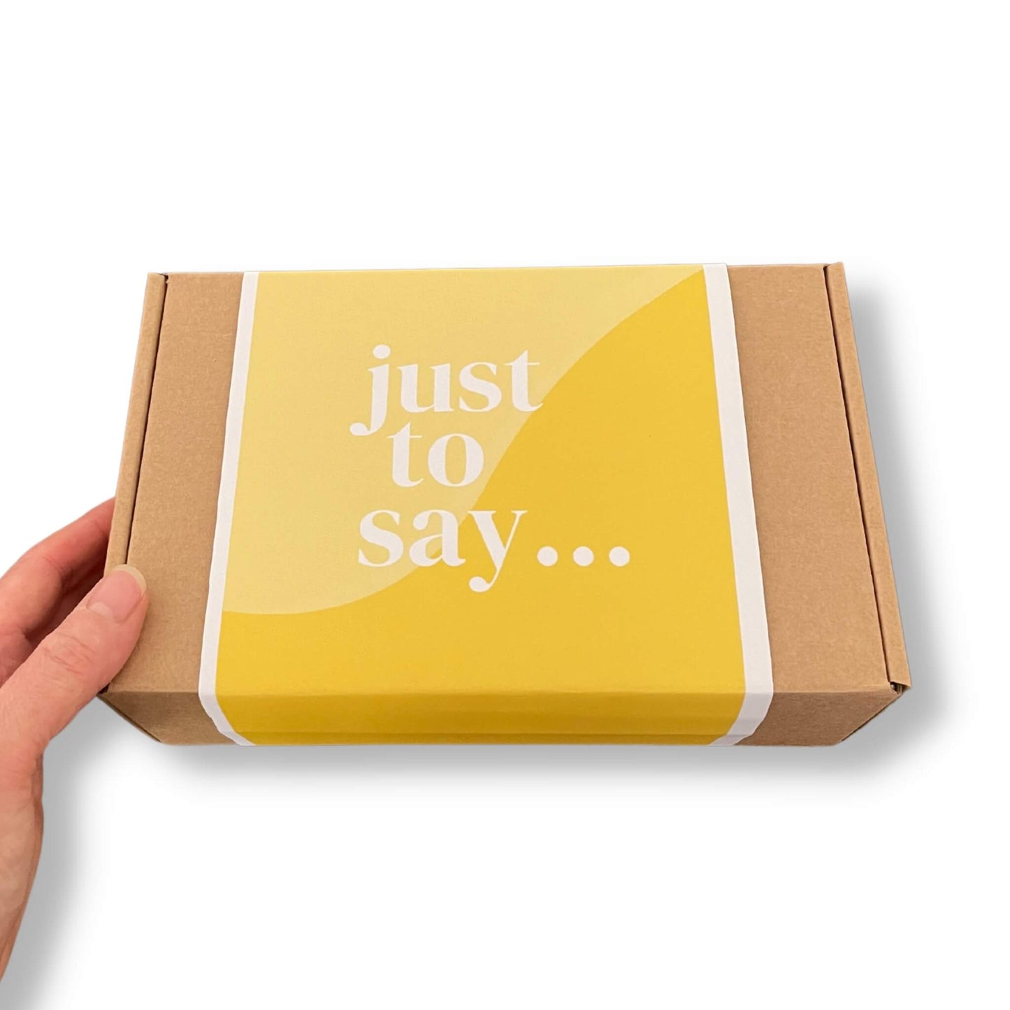 Kraft gift box with a yellow sleeve and 'just to say...' message on the front