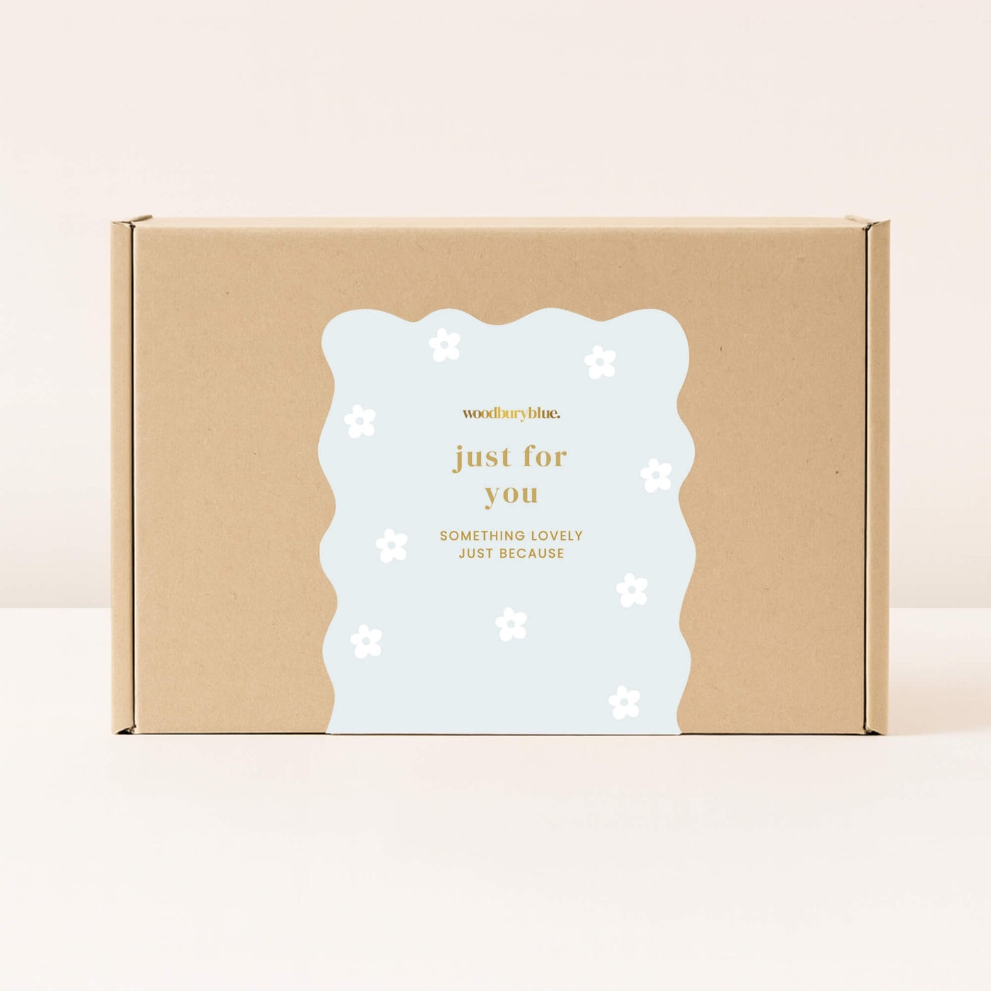 Kraft gift box with pale blue just for you sticker decorated with simple white daisy flowers from Woodbury Blue