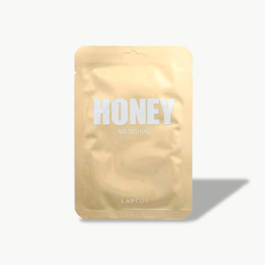 LAPCOS Honey Nourishing sheet mask in gold metallic pouch with shadow on light background