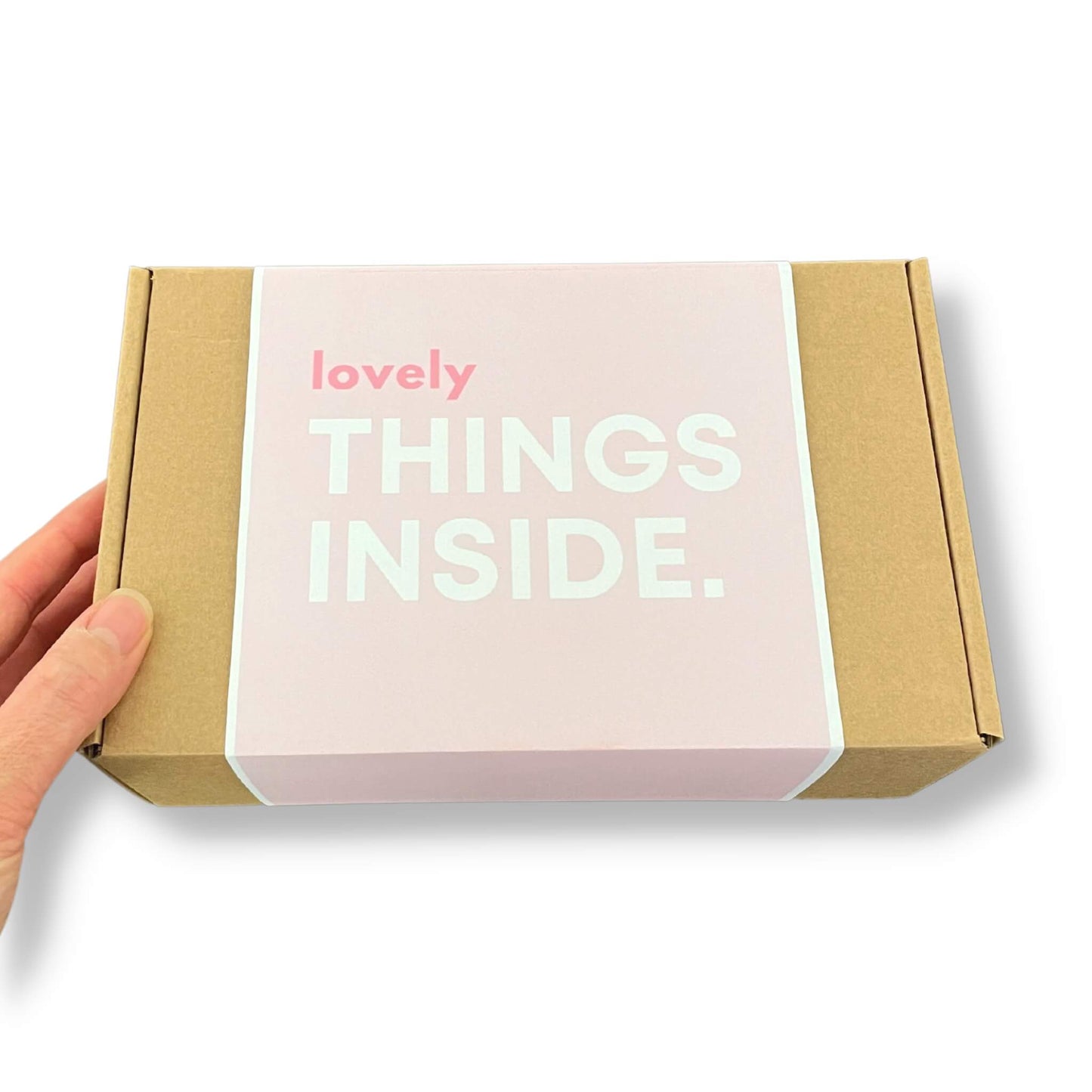 Kraft gift box with a pink sleeve and 'lovely things inside' on the front