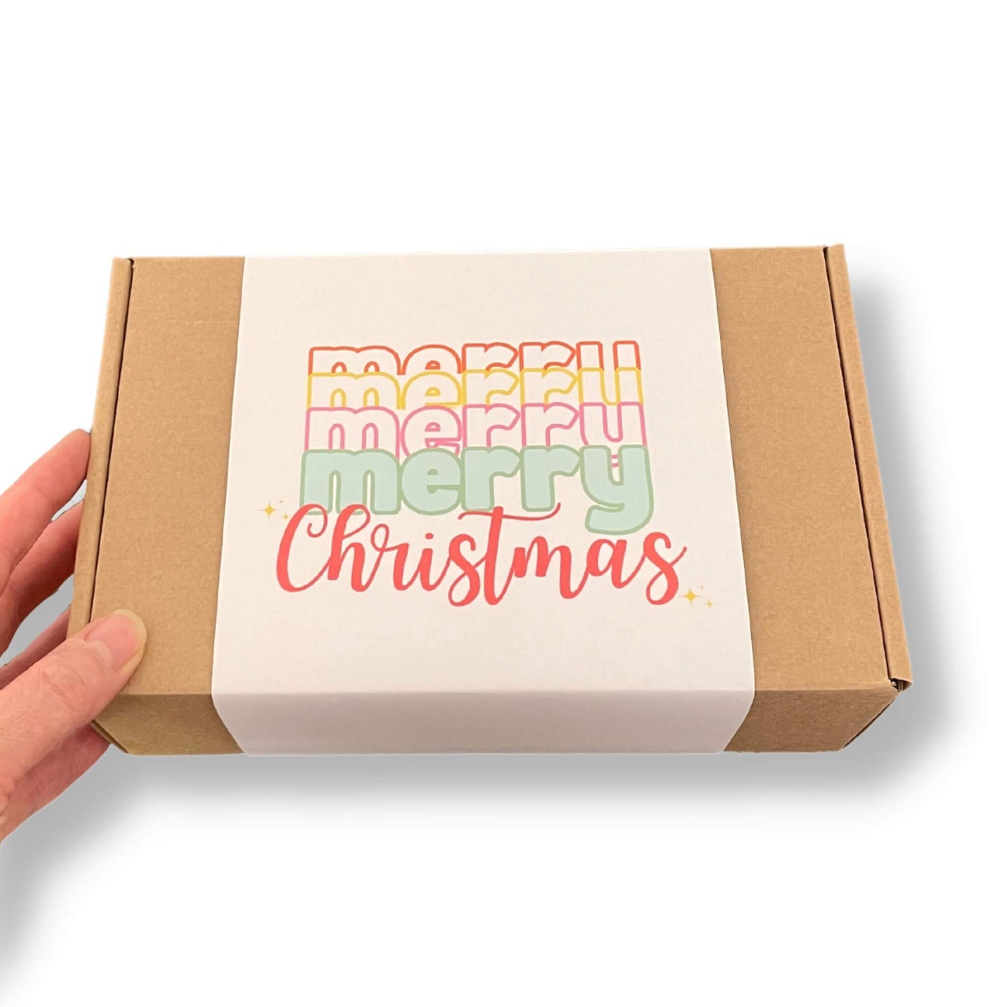 Kraft gift box with a cream coloured sleeve and merry christmas text on the front