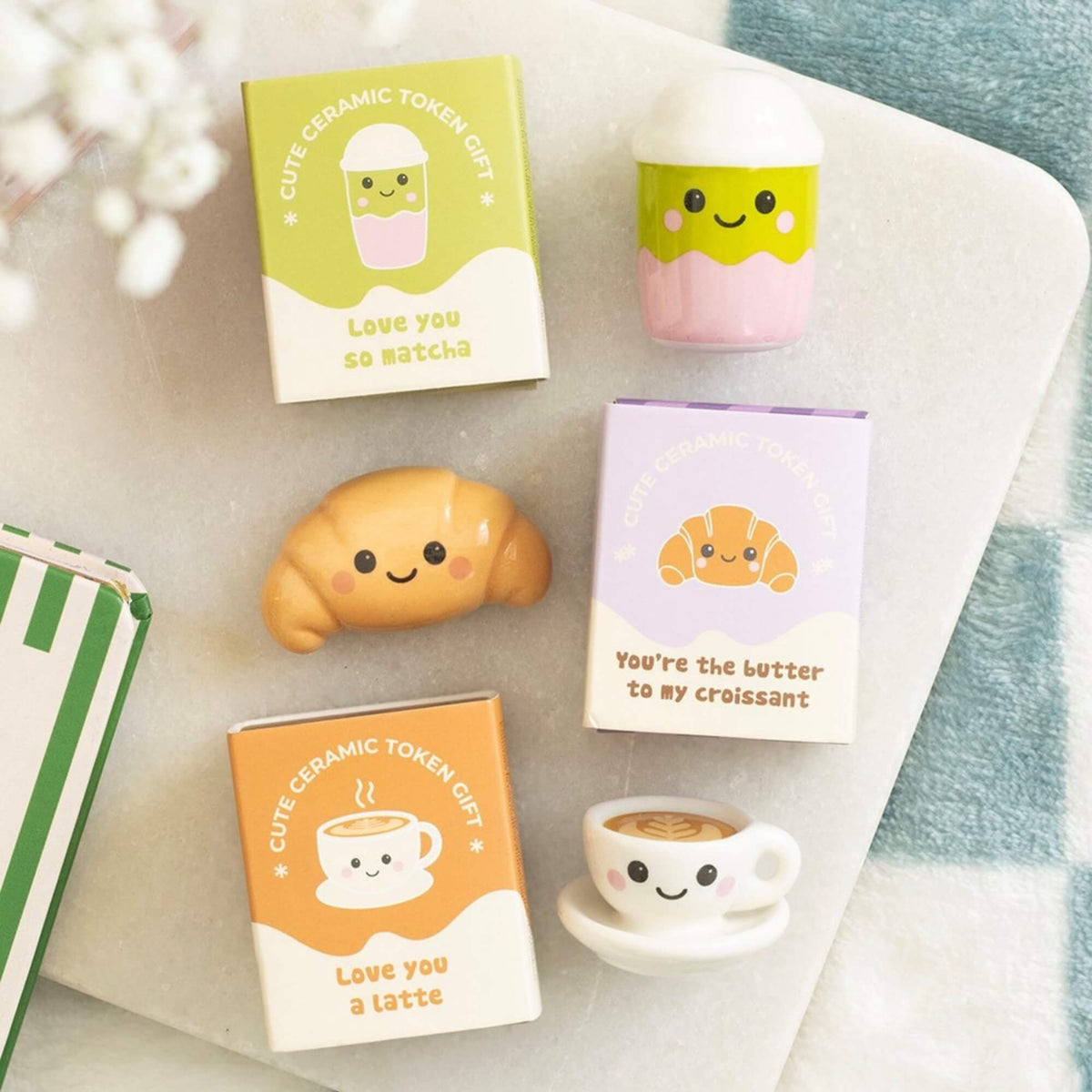 Matcha cup, latte cup and croissant ceramic token gifts displayed with their mini gift boxes
