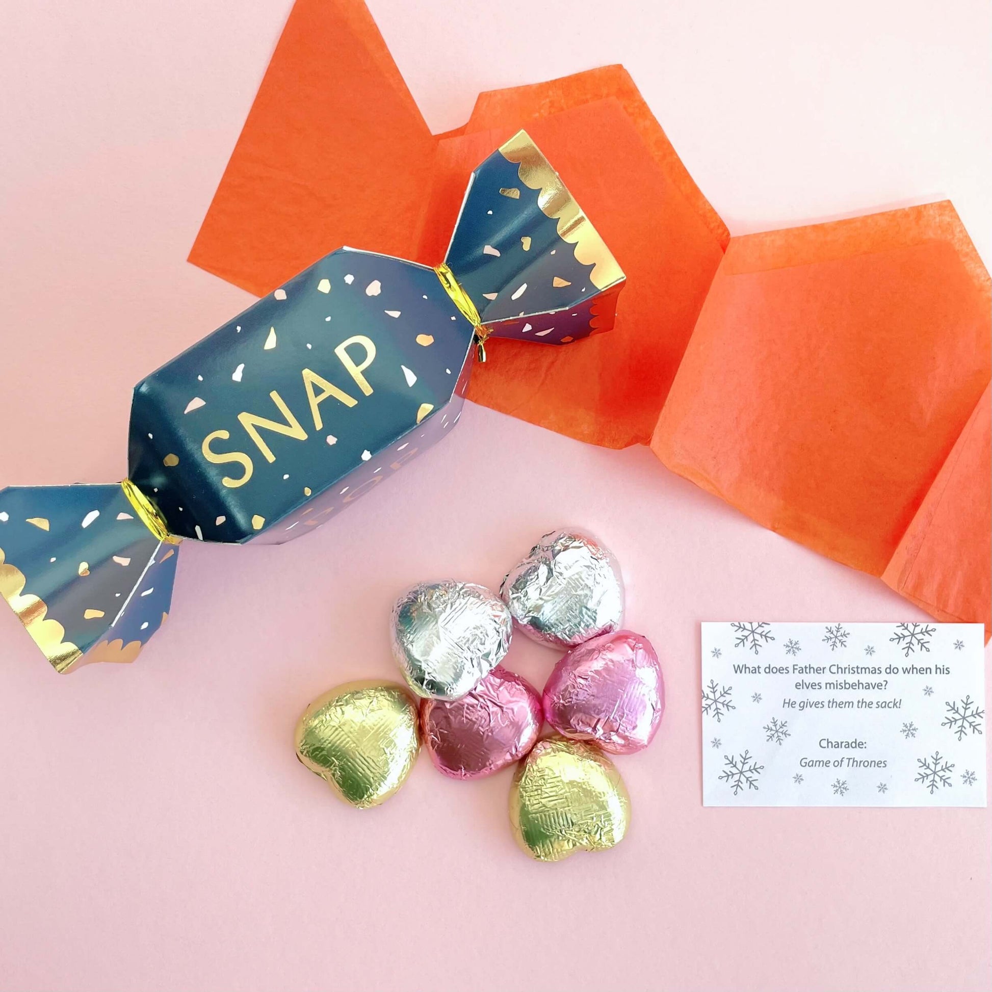 Mini blue and gold christmas cracker filled with milk chocolate, hat, snap and joke