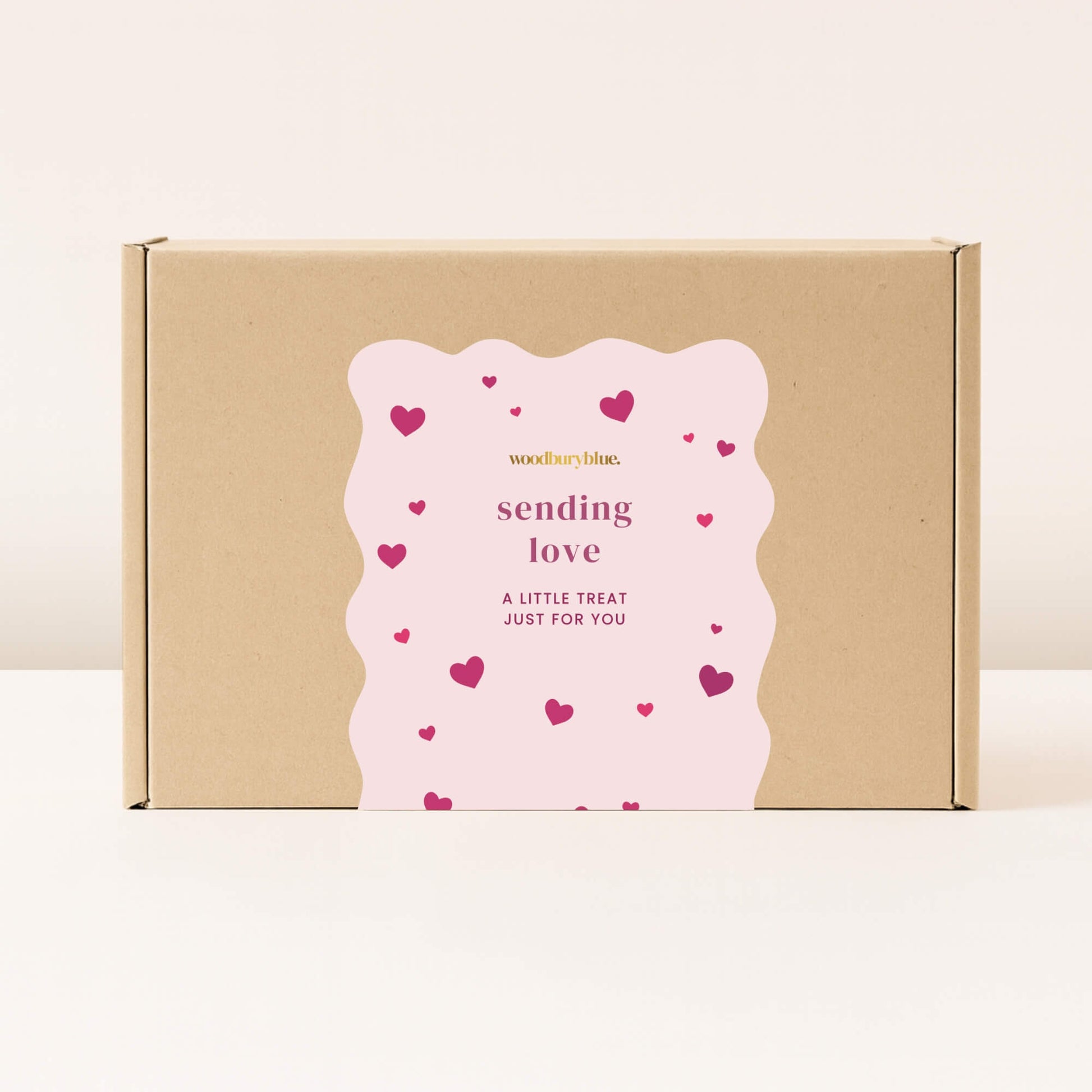 Mystery Valentine’s and Galentine’s gift box in a kraft box with a pink “sending love” label and heart details