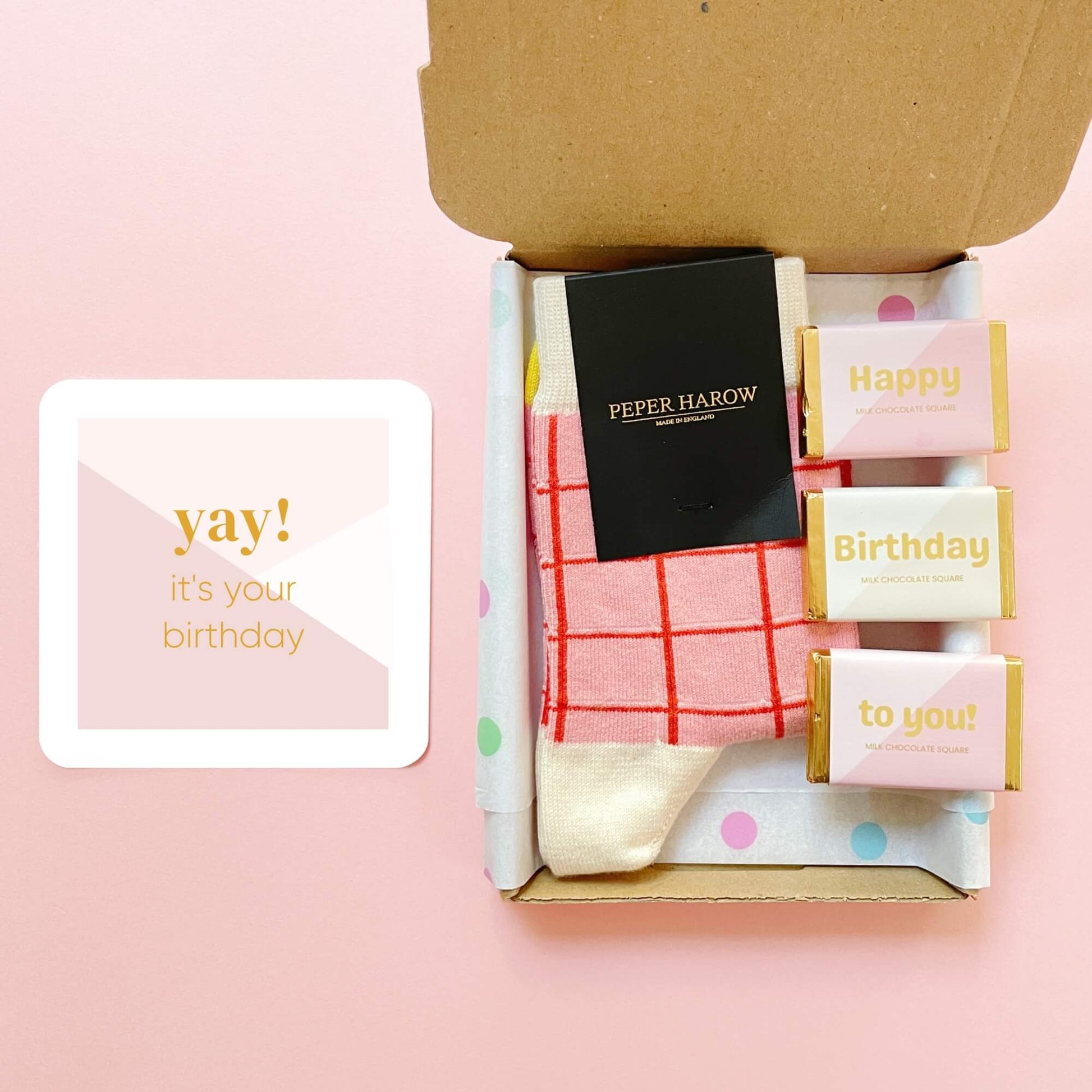 Open birthday gift box showing Peper Harow socks, birthday chocolates and yay it’s your birthday card by Woodbury Blue.